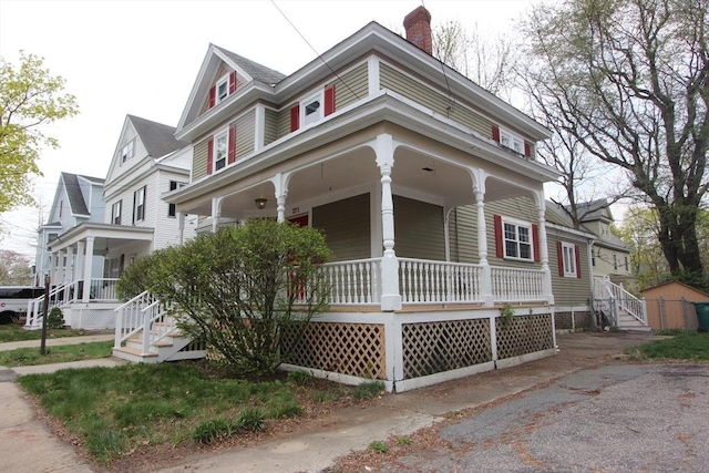 271 Gibson St, Lowell, MA 01851 - view of front of house featuring a porch and a chimney