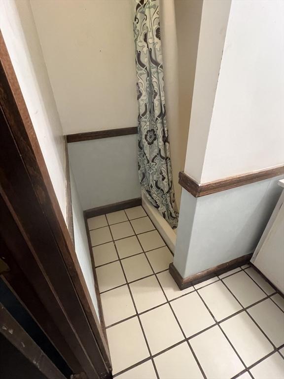 271 Gibson St, Lowell, MA 01851 - bathroom featuring baseboards, tile patterned flooring, and a shower with curtain