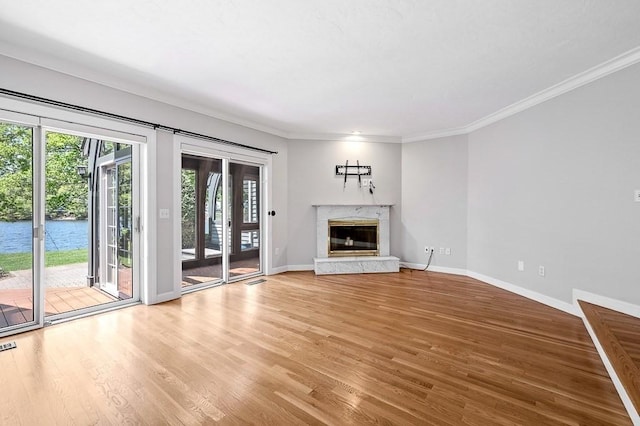 30 Eastern Point Dr Unit 30, Shrewsbury, MA 01545 - unfurnished living room with light wood-type flooring, baseboards, a high end fireplace, crown molding, and a water view