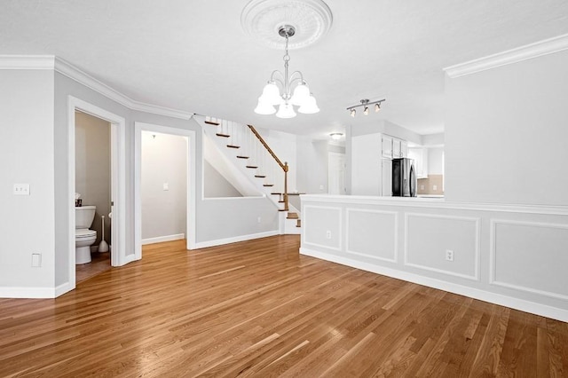 30 Eastern Point Dr Unit 30, Shrewsbury, MA 01545 - unfurnished dining area featuring a chandelier, stairway, light wood finished floors, crown molding, and baseboards