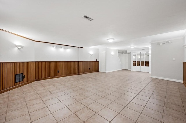 30 Eastern Point Dr Unit 30, Shrewsbury, MA 01545 - spare room featuring wainscoting, wooden walls, crown molding, and light tile patterned floors