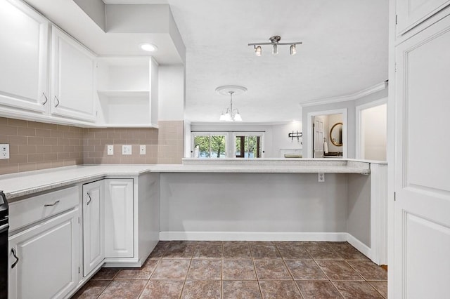 30 Eastern Point Dr Unit 30, Shrewsbury, MA 01545 - kitchen featuring open shelves, white cabinetry, backsplash, a chandelier, and baseboards