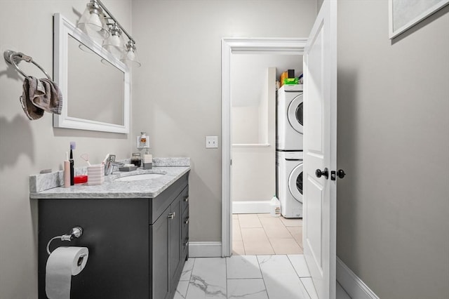 bathroom with stacked washer and dryer and vanity