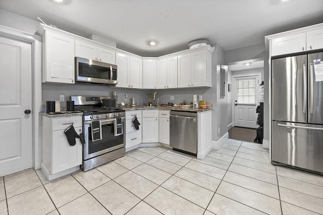 kitchen featuring light tile patterned flooring, sink, white cabinetry, and stainless steel appliances