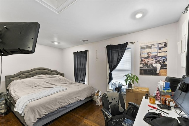 bedroom with dark hardwood / wood-style flooring