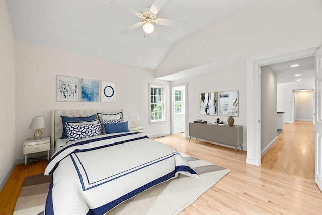 bedroom with lofted ceiling, light wood-type flooring, and ceiling fan