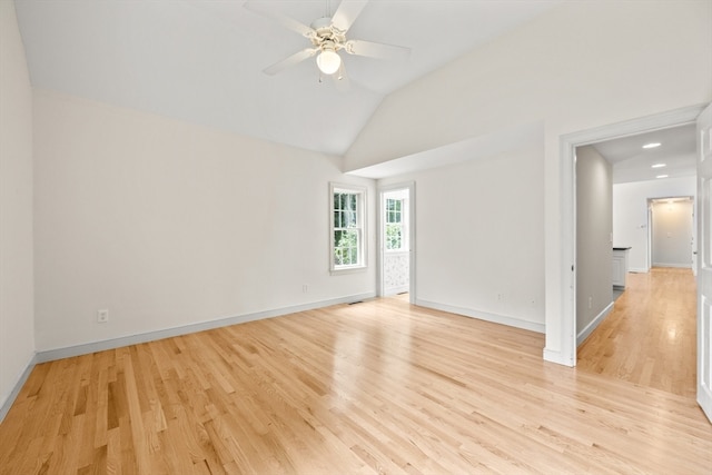 unfurnished room featuring ceiling fan, lofted ceiling, and light hardwood / wood-style floors