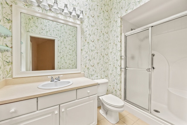 bathroom with tile patterned floors, vanity, an enclosed shower, and toilet