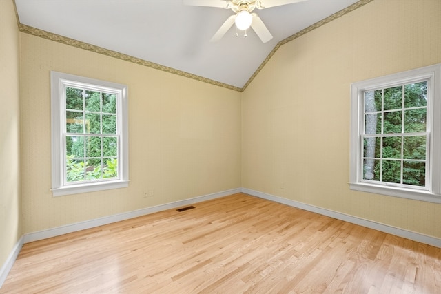 unfurnished room with ceiling fan, lofted ceiling, and light hardwood / wood-style floors