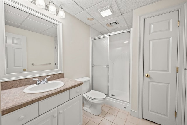 bathroom featuring walk in shower, toilet, a paneled ceiling, tile patterned flooring, and vanity