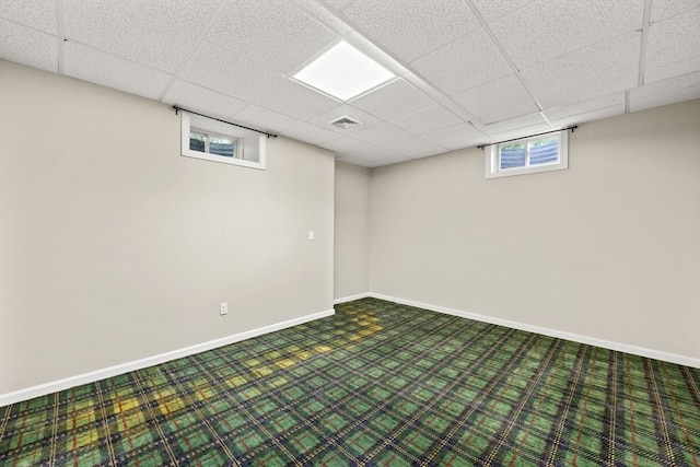 basement with a paneled ceiling