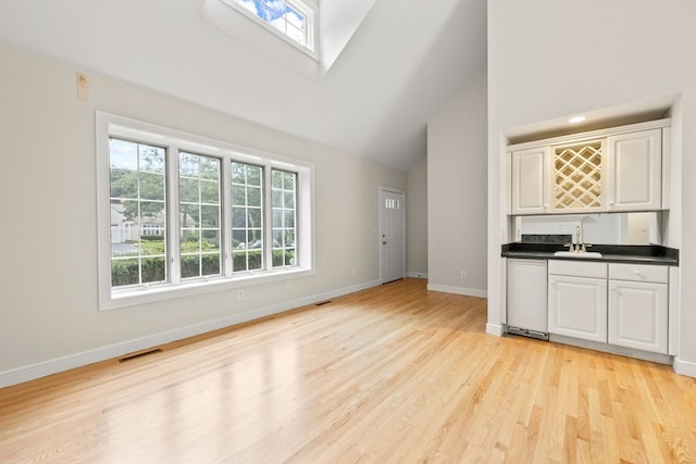 kitchen with light wood-type flooring, plenty of natural light, and dishwasher