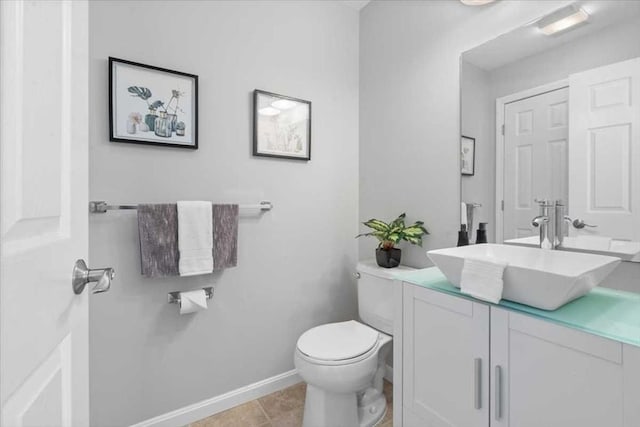 bathroom with vanity, toilet, and tile patterned flooring