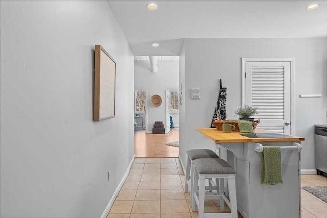 corridor featuring light tile patterned floors