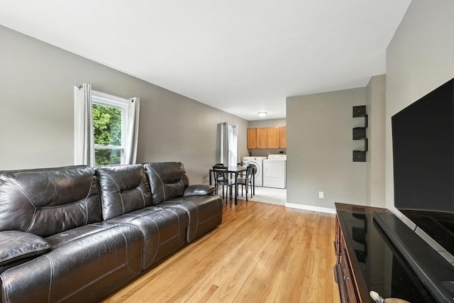 14 Carlton St, South Hadley, MA 01075 - living room featuring washing machine and dryer and light wood-type flooring