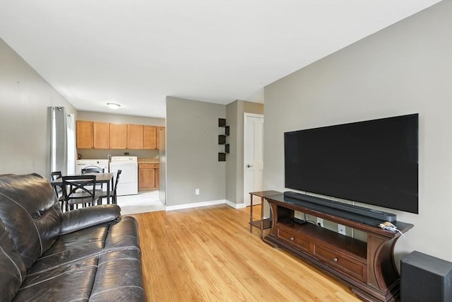 14 Carlton St, South Hadley, MA 01075 - living area with light wood-style flooring and independent washer and dryer