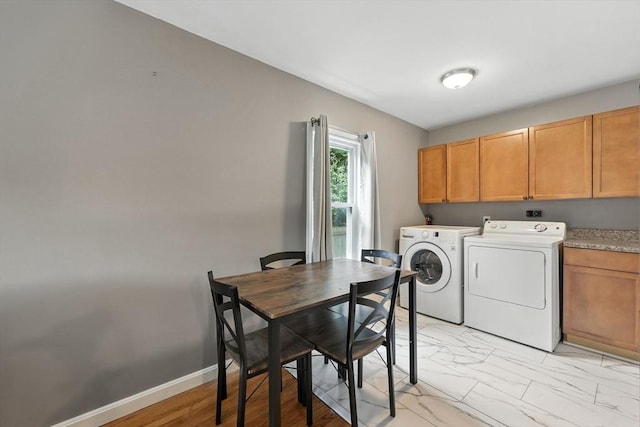 14 Carlton St, South Hadley, MA 01075 - laundry room with washer and clothes dryer, light marble finish floors, and cabinet space