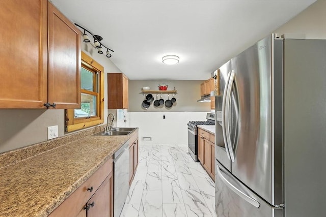 14 Carlton St, South Hadley, MA 01075 - kitchen featuring stainless steel appliances, light marble finish flooring, brown cabinets, and under cabinet range hood