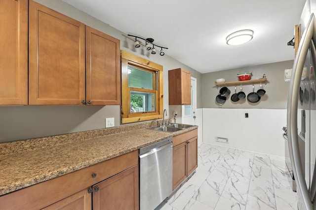 14 Carlton St, South Hadley, MA 01075 - kitchen with stainless steel dishwasher, light marble finish floors, and brown cabinets