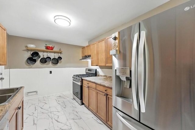 14 Carlton St, South Hadley, MA 01075 - kitchen featuring appliances with stainless steel finishes, under cabinet range hood, light marble finish flooring, and light countertops