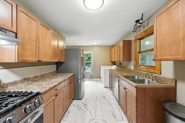 14 Carlton St, South Hadley, MA 01075 - kitchen featuring washing machine and dryer, light marble finish floors, stainless steel appliances, under cabinet range hood, and light countertops