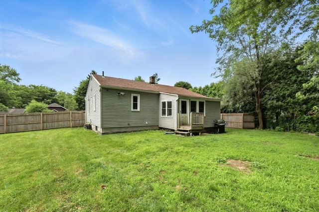 14 Carlton St, South Hadley, MA 01075 - rear view of house with a chimney and a fenced backyard