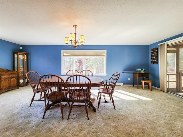 carpeted dining room with a textured ceiling, baseboards, and an inviting chandelier