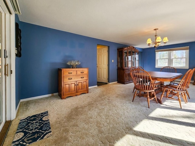 carpeted dining area with baseboards and an inviting chandelier