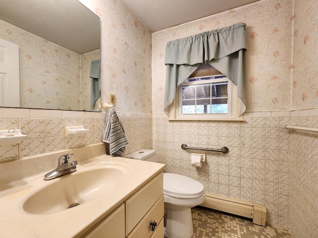 bathroom with toilet, a baseboard radiator, vanity, and wallpapered walls