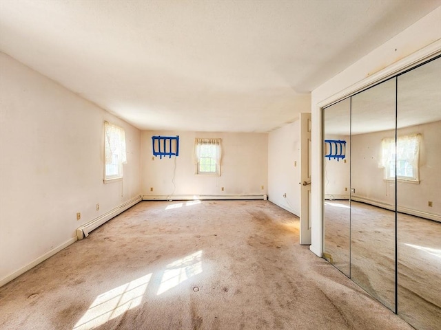 interior space featuring baseboard heating and a closet