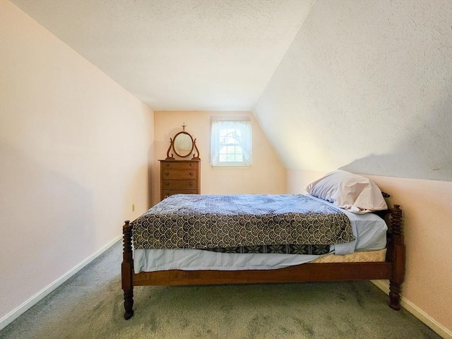 bedroom featuring carpet floors, vaulted ceiling, a textured ceiling, and baseboards