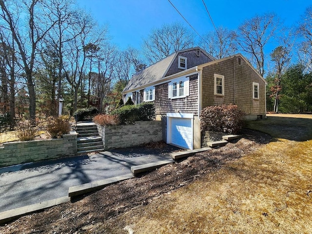 view of home's exterior with a garage and driveway