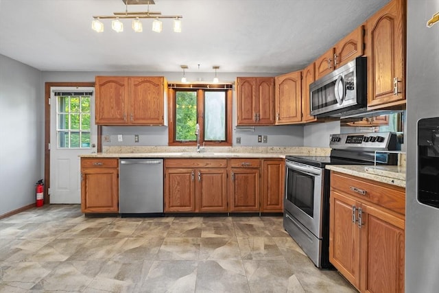 18 Bismark St, Dedham, MA 02026 - kitchen featuring appliances with stainless steel finishes and brown cabinetry