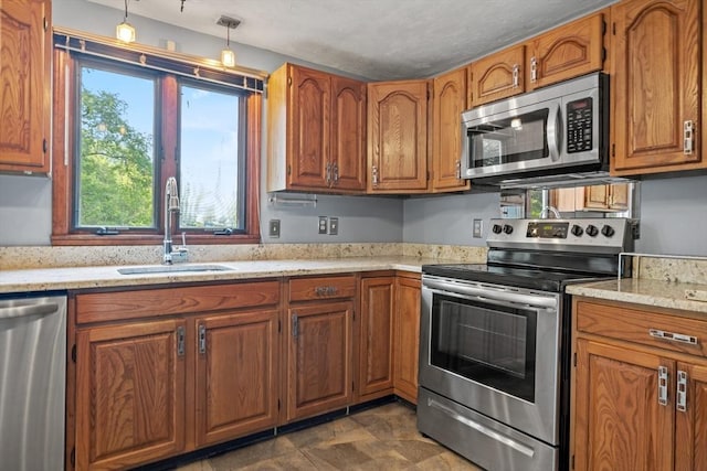 18 Bismark St, Dedham, MA 02026 - kitchen featuring stainless steel appliances, brown cabinets, pendant lighting, and light stone countertops