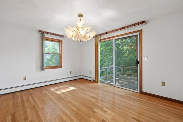 18 Bismark St, Dedham, MA 02026 - unfurnished room with a chandelier, light wood-style flooring, and a baseboard heating unit