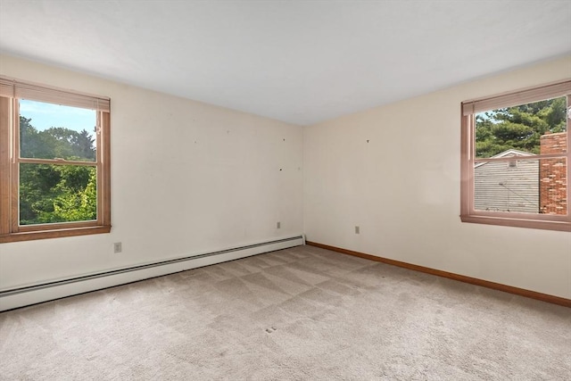 18 Bismark St, Dedham, MA 02026 - empty room featuring light colored carpet, healthy amount of natural light, and a baseboard heating unit