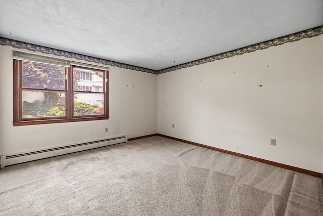 18 Bismark St, Dedham, MA 02026 - spare room with a baseboard heating unit and light carpet
