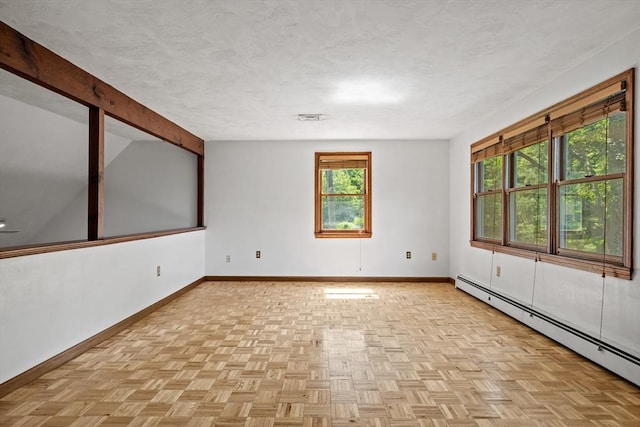 18 Bismark St, Dedham, MA 02026 - spare room featuring a baseboard heating unit, beam ceiling, and a textured ceiling