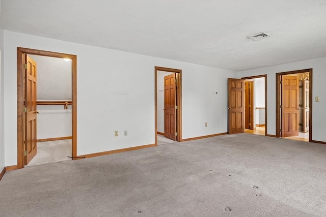 18 Bismark St, Dedham, MA 02026 - unfurnished bedroom featuring a spacious closet, light carpet, and a closet