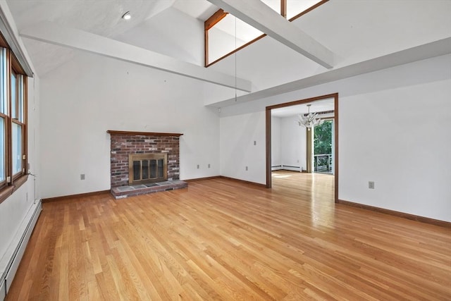 18 Bismark St, Dedham, MA 02026 - unfurnished living room with a baseboard radiator, high vaulted ceiling, a chandelier, light wood-type flooring, and a brick fireplace