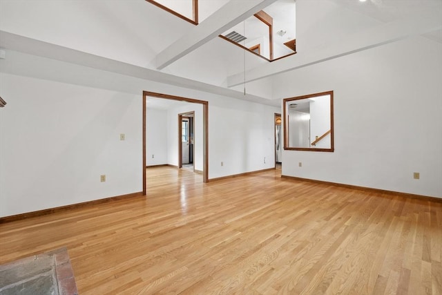 18 Bismark St, Dedham, MA 02026 - empty room featuring high vaulted ceiling and light wood-style flooring