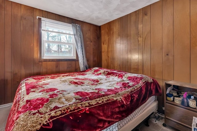 bedroom featuring wooden walls