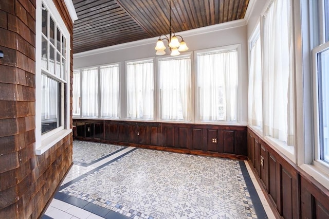 unfurnished sunroom with wooden ceiling and a chandelier