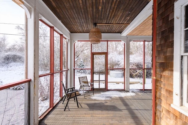 unfurnished sunroom with a healthy amount of sunlight and wood ceiling