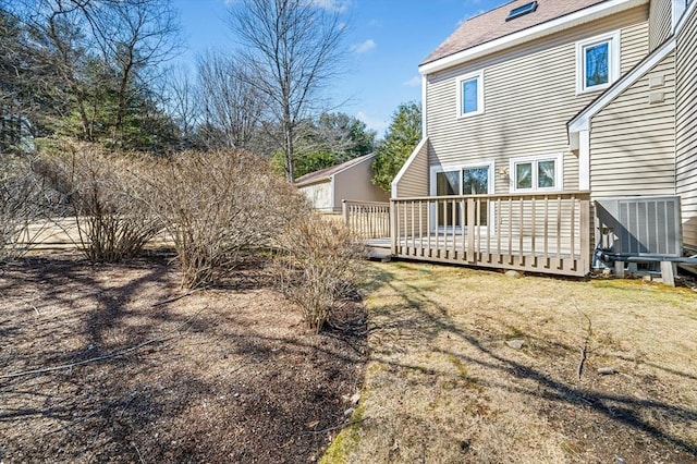 back of property featuring central air condition unit and a wooden deck