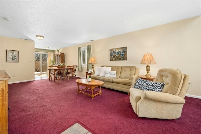 carpeted living room featuring baseboards and a textured ceiling