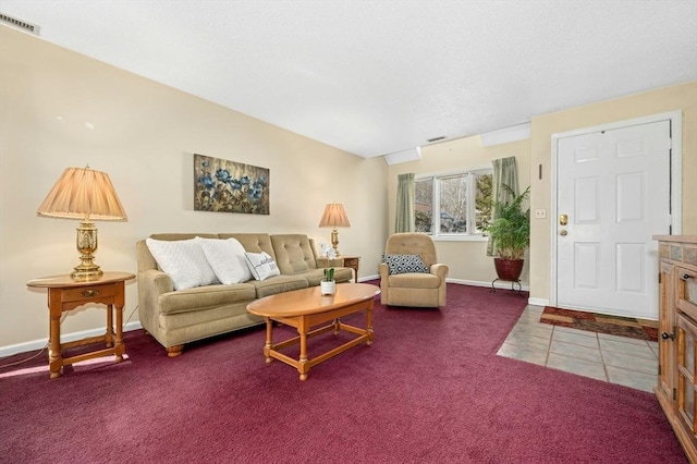 carpeted living area featuring tile patterned flooring, baseboards, and visible vents