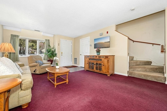 carpeted living area with stairway, baseboards, a textured ceiling, and visible vents