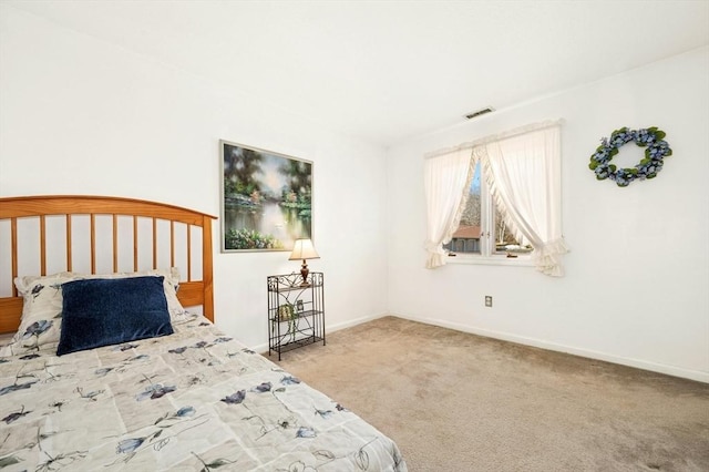 carpeted bedroom with visible vents and baseboards