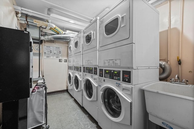 laundry area featuring sink, stacked washing maching and dryer, and independent washer and dryer